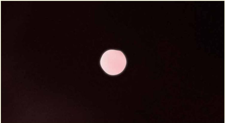 A pink orb against a dark background