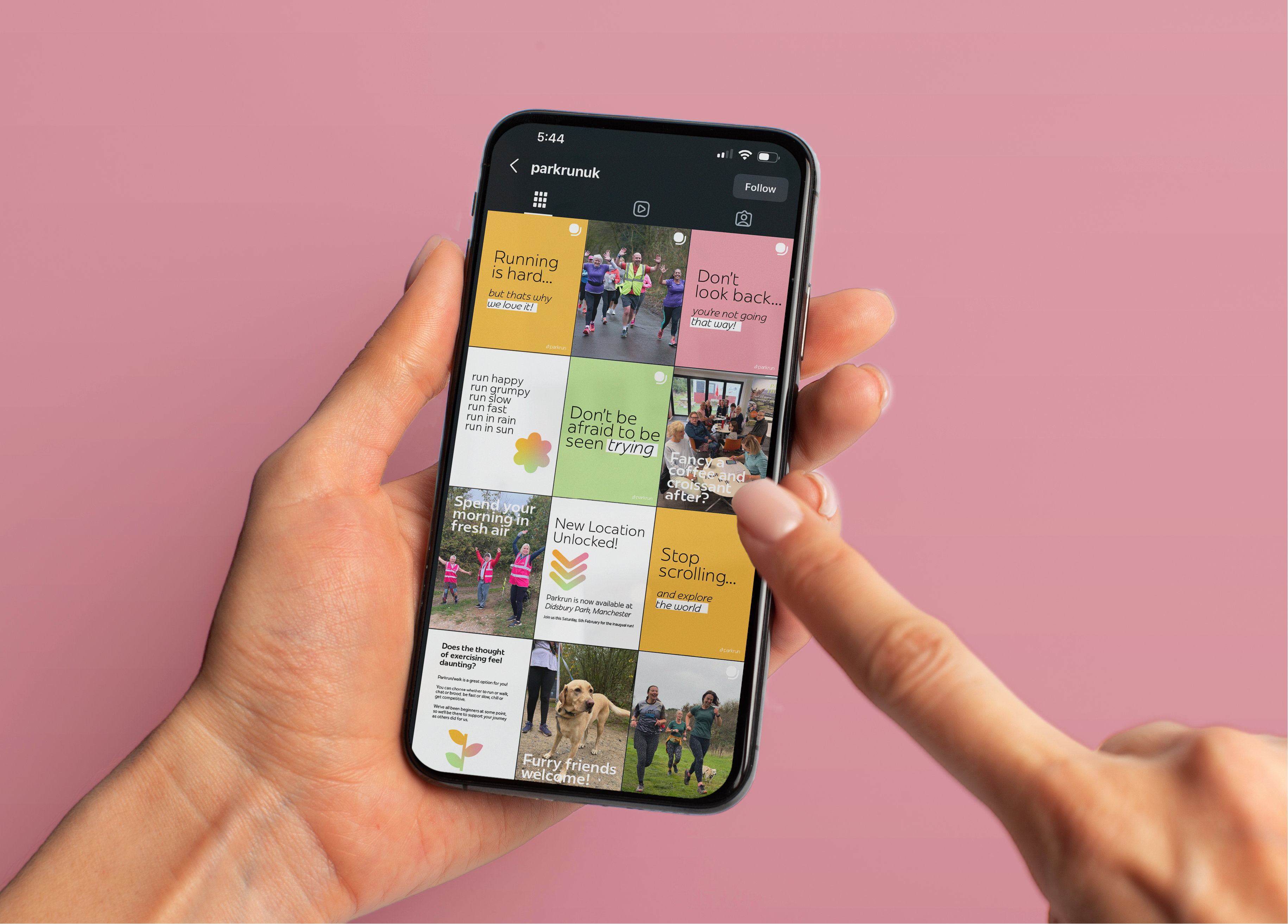 A hand holding a phone showing the parkrun Instagram feed with bright, motivational posts