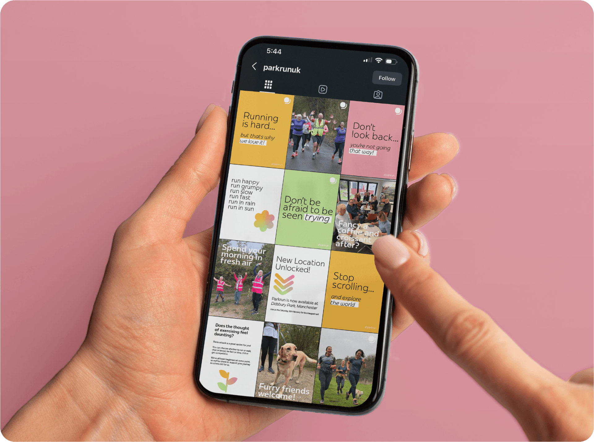 A hand holding a phone showing the parkrun Instagram feed